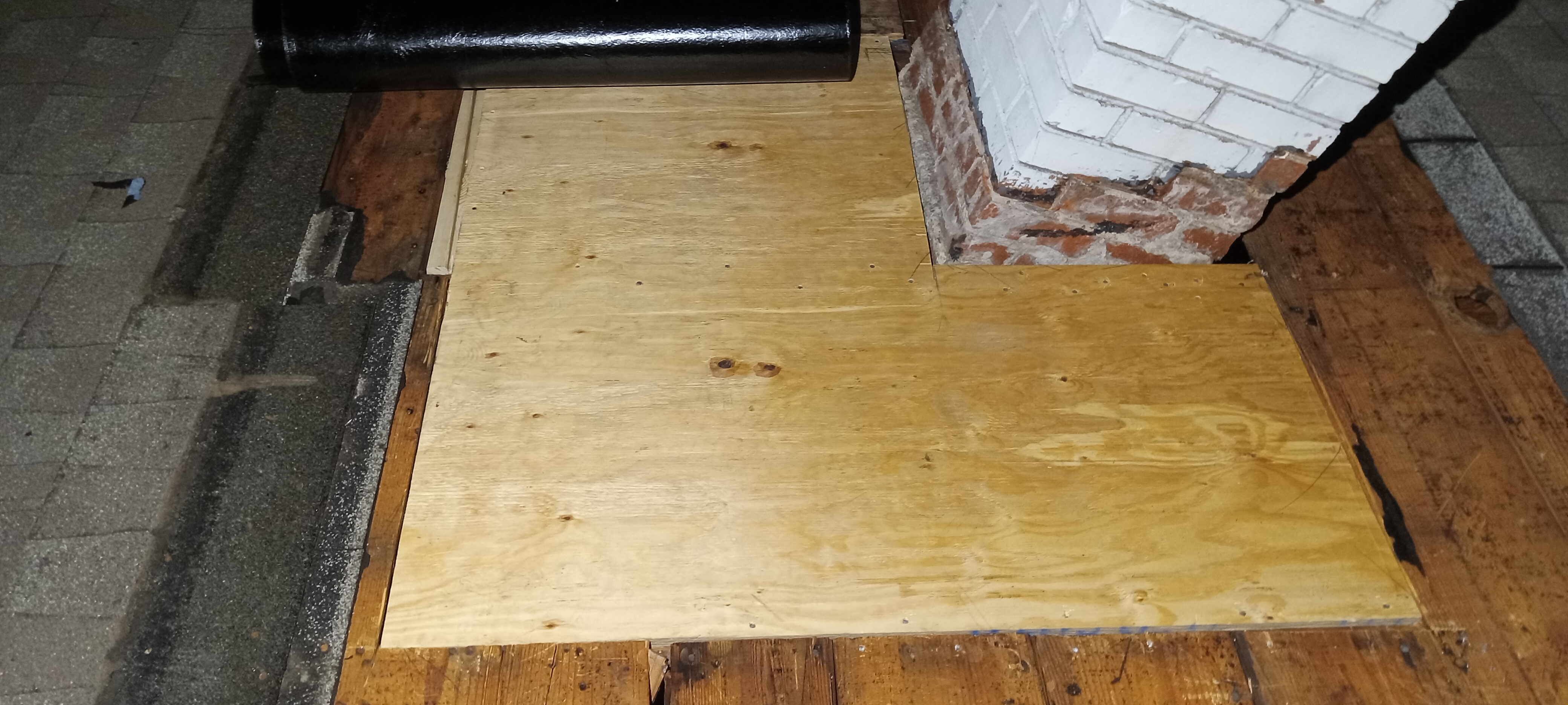 Replacement roof sheathing fitted around a chimney